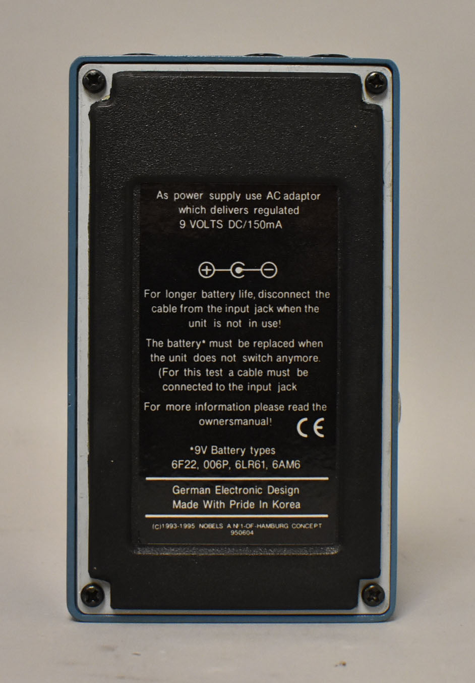 The switcher pedal's blue-gray bottom plate is visible, with a black textured label covering most of the surface.