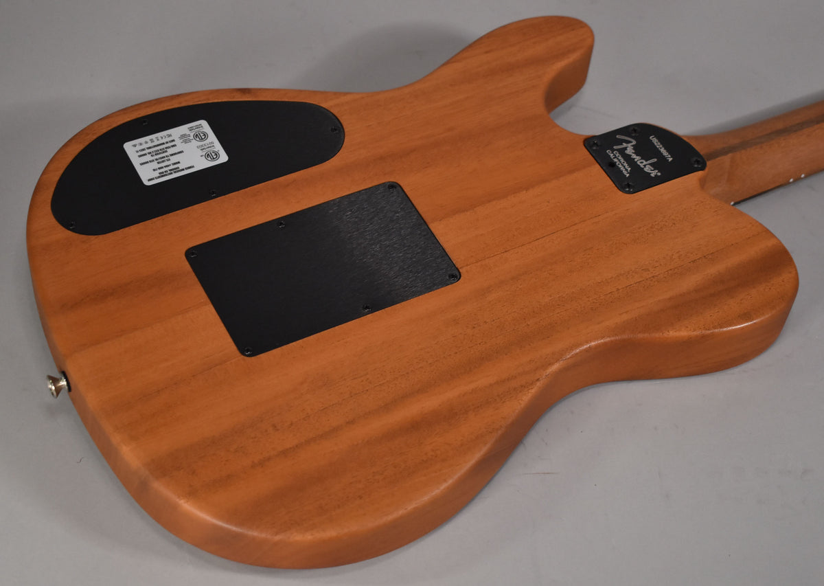 The guitar's back, a light brown wood with visible grain, features two black control cavity covers and a chrome strap button.