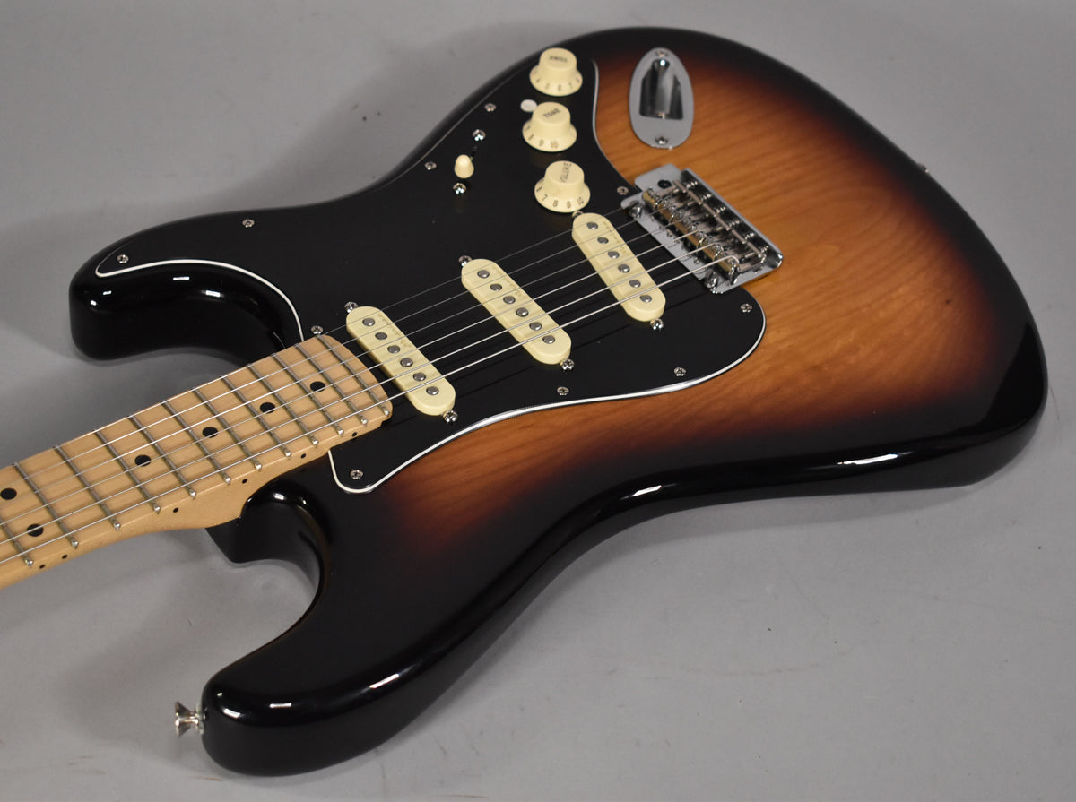 A 3-tone sunburst electric guitar with a black pickguard, three cream single-coil pickups, and a maple fretboard.