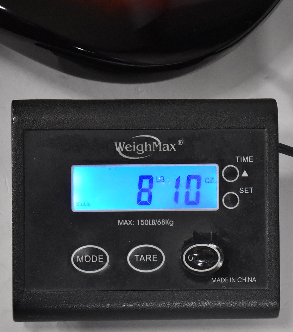 The guitar's 3-Tone Sunburst body rests on a black digital scale displaying "8 LB 10 OZ" in blue, with "Stable" lit up.