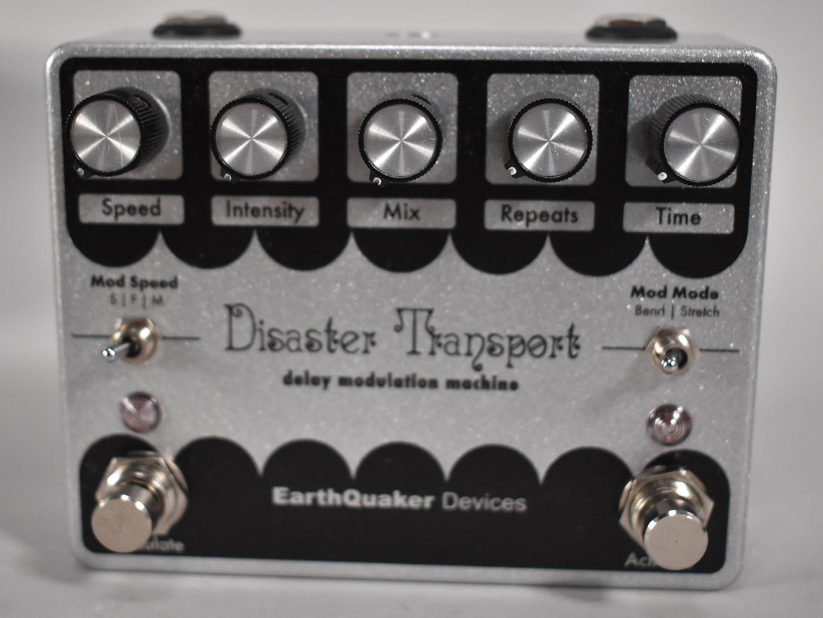 Front view of a silver glitter pedal with five black knobs, two toggle switches, and two footswitches.