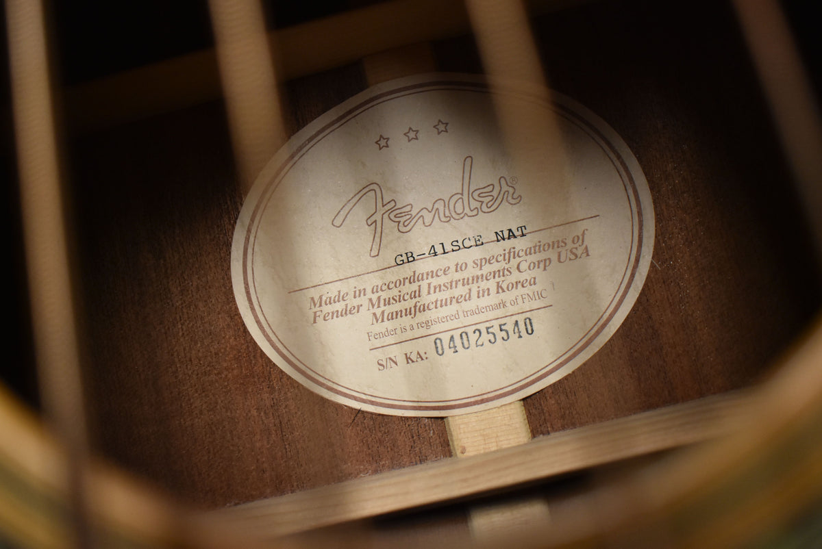 Close-up of the oval label inside the soundhole, showing the serial number and "Manufactured in Korea" text.