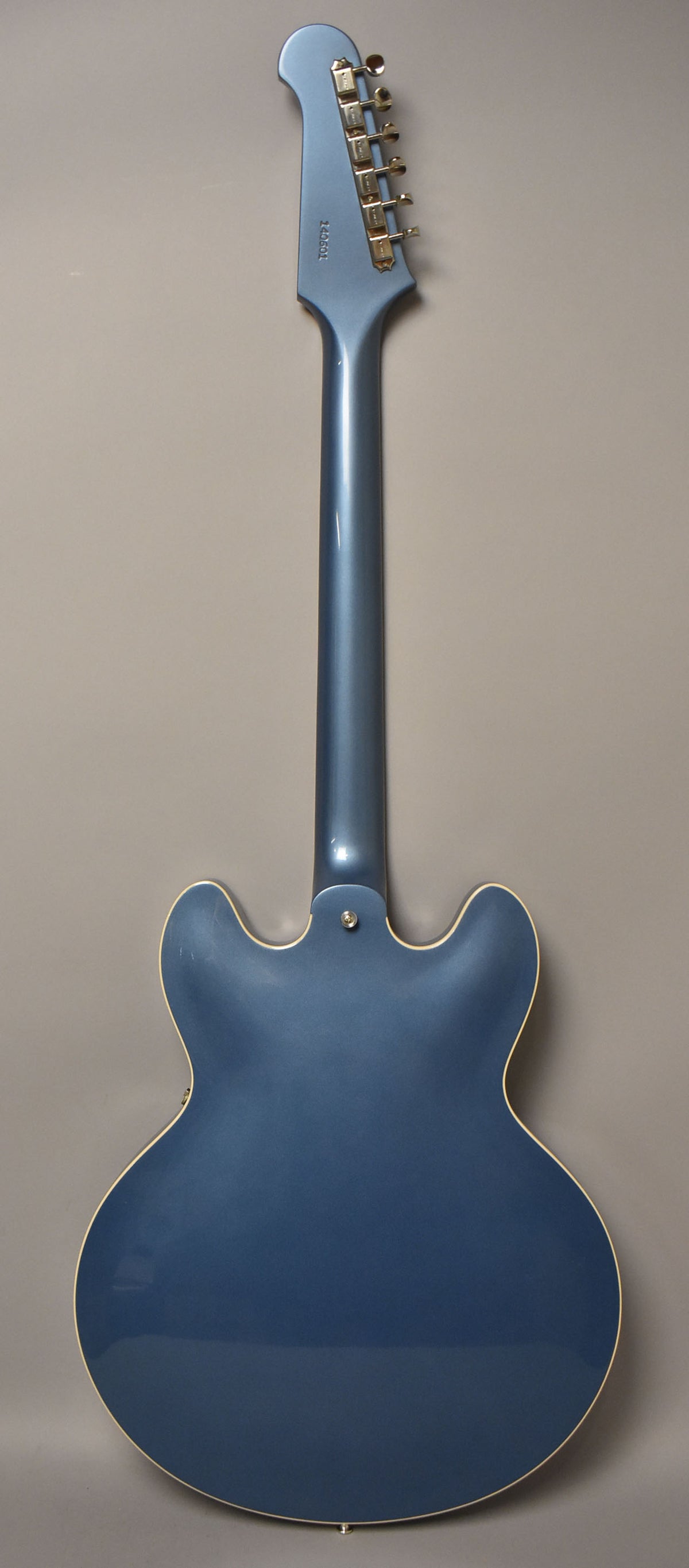 Full back view of a Pelham Blue semi-hollow electric guitar with a gloss finish, cream binding, and gold tuners.