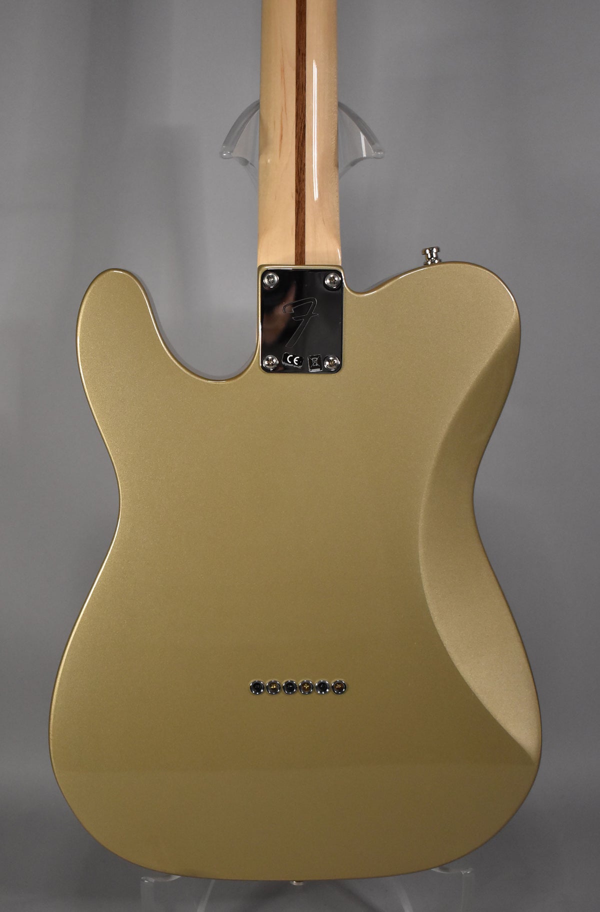 Rear view of a Shoreline Gold Telecaster Deluxe, showing the neck plate, maple neck, and six string-through-body ferrules.