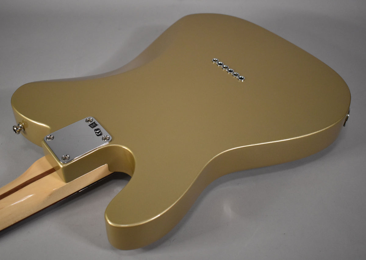 The back of a Shoreline Gold guitar, showing the neck plate, strap button, and six string-through-body ferrules.