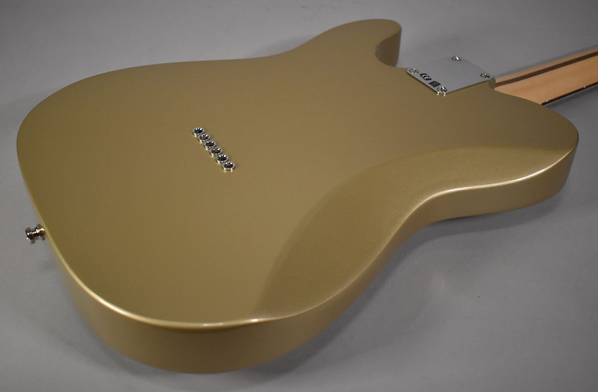 The Shoreline Gold Telecaster's back, angled from the lower bout, shows six string ferrules, a chrome neck plate, and a strap button.