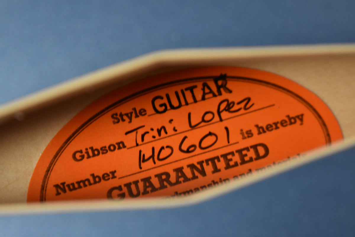 Close-up of the orange oval label inside the guitar's soundhole, showing "Style GUITAR" and "Gibson Trini Lopez" handwritten.
