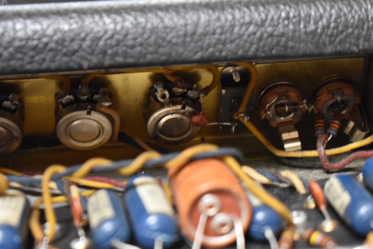 Close-up of the amplifier's internal wiring and components, showing several potentiometers, capacitors, and resistors.