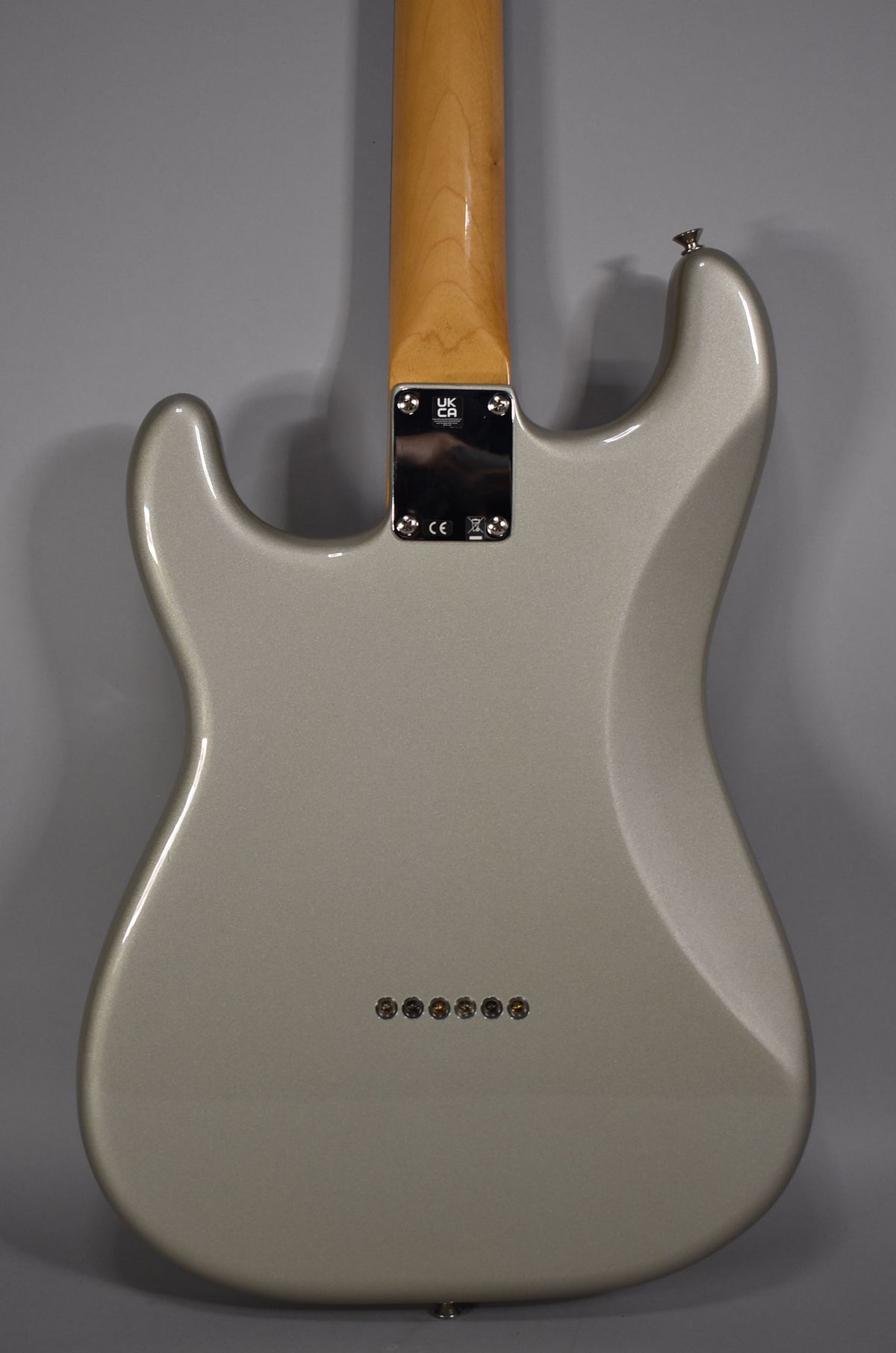The back of the Inca Silver Stratocaster shows a glossy finish, a maple neck, and six string-through-body ferrules.