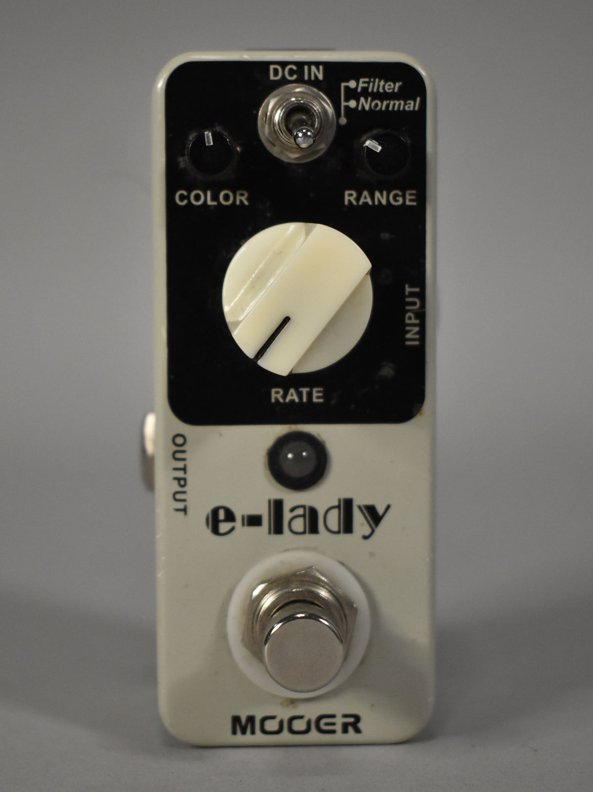 A cream-colored pedal with a black control panel, featuring a large cream "RATE" knob, two smaller black knobs, and a toggle switch.