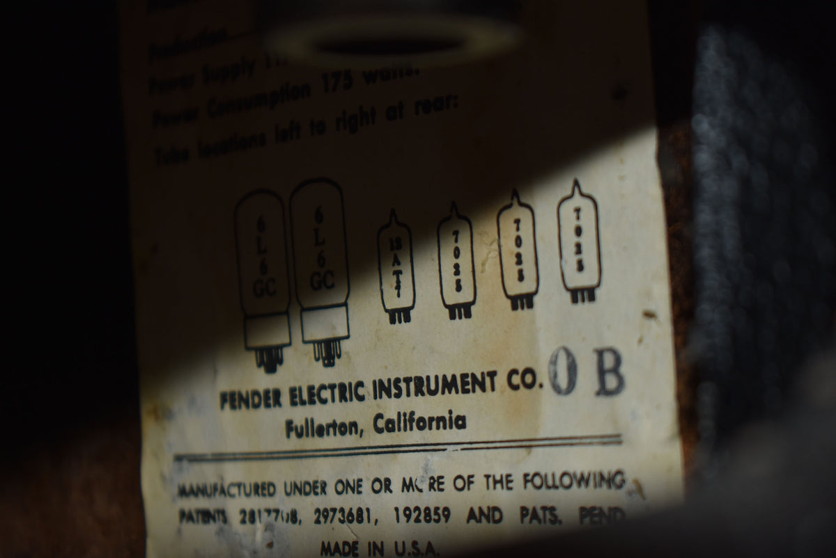 Close-up of a faded, yellowed paper label with black text, showing tube diagrams and patent information.