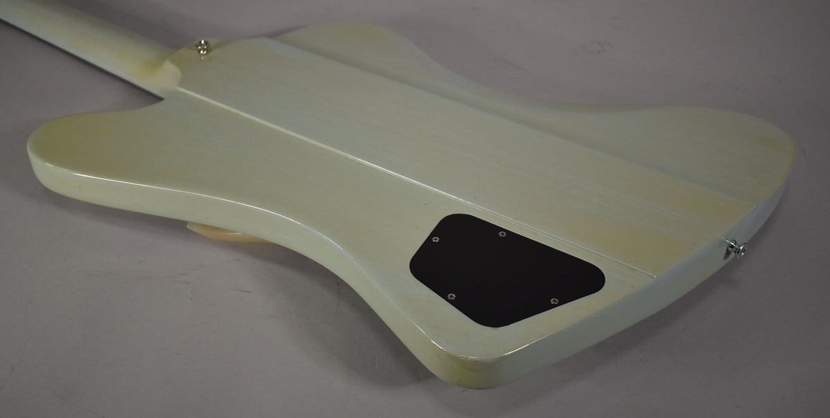 The back of the light blue guitar body, angled from the neck, shows a black control cavity cover and light finish wear.
