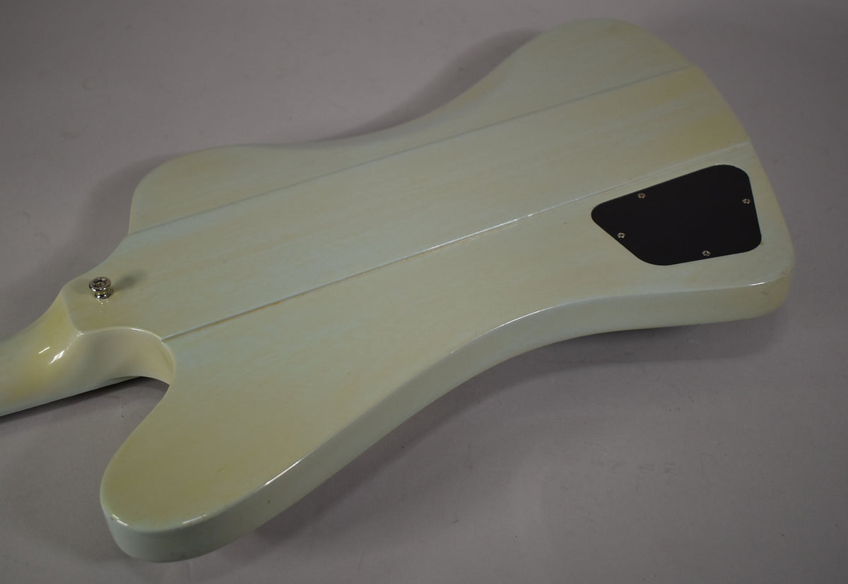 The back of the Frost Blue Firebird body, showing the neck joint, black control cavity cover, and light finish checking.
