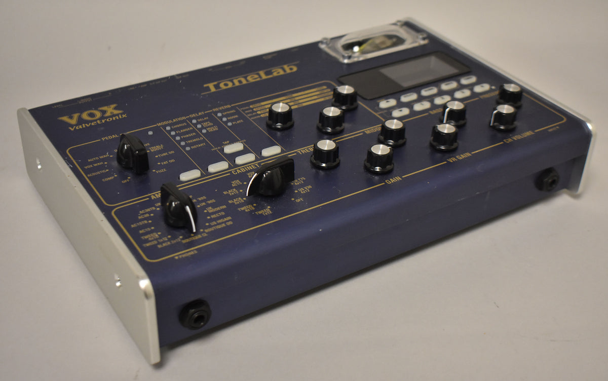 A blue multi-effects pedal with silver end panels, a small screen, and numerous black knobs and white buttons, viewed from the right.