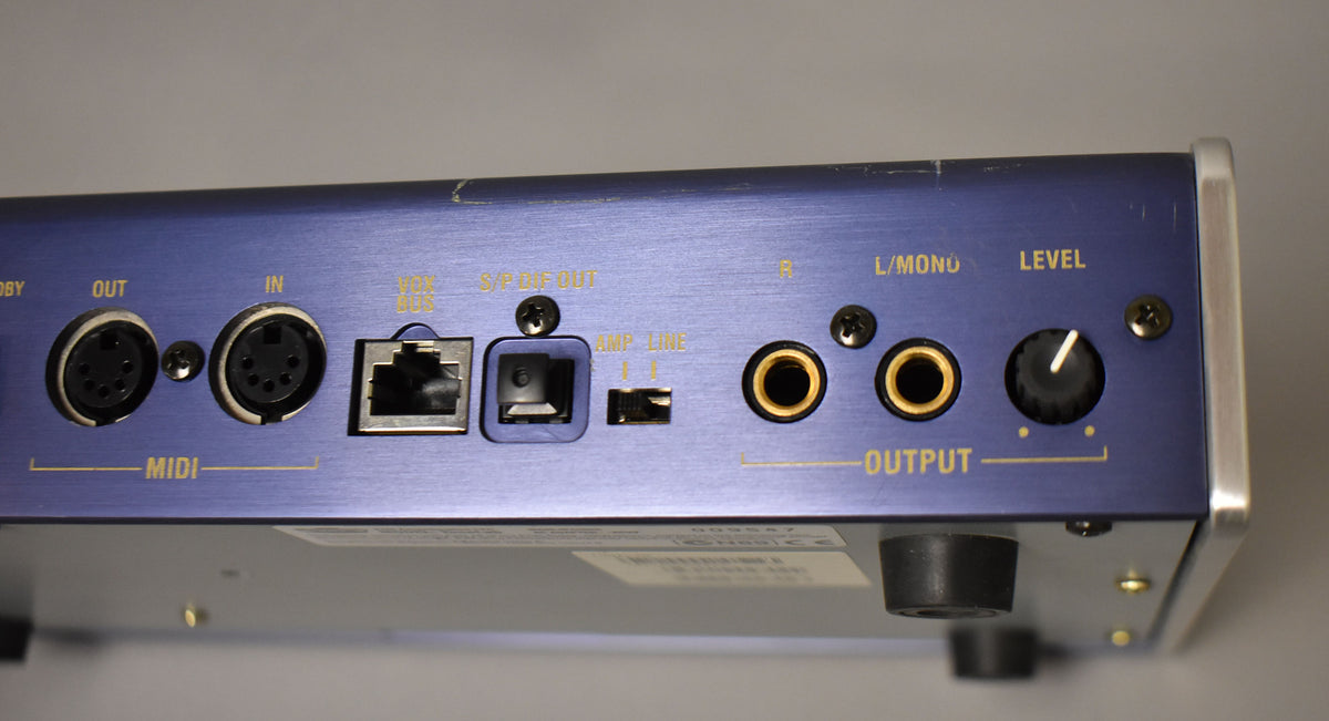 The blue brushed metal rear panel shows MIDI in/out, USB, S/P DIF out, Amp/Line switch, two 1/4" outputs, and a Level knob.