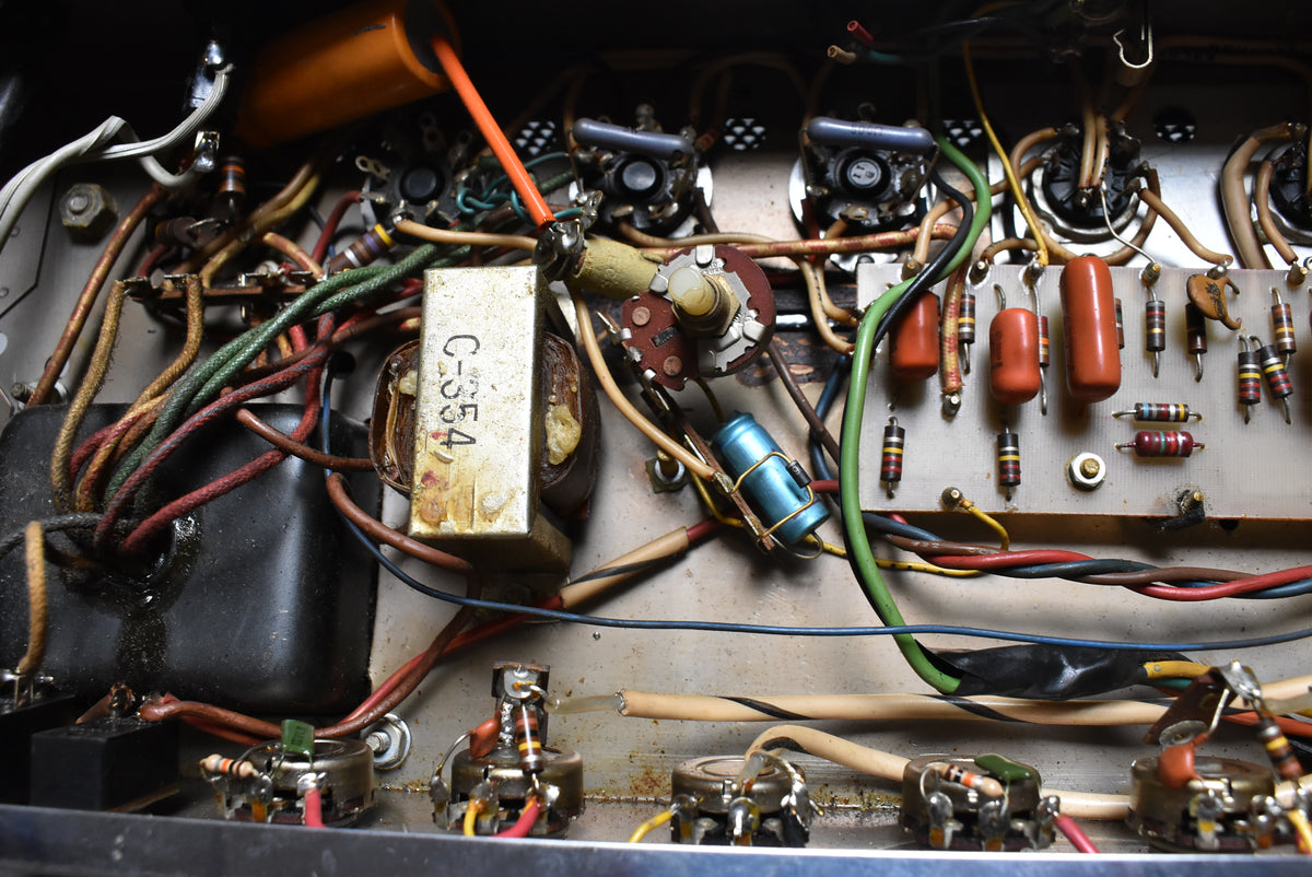 Close-up of the amplifier's internal wiring, showing a dense network of colorful wires, resistors, capacitors, and transformers.