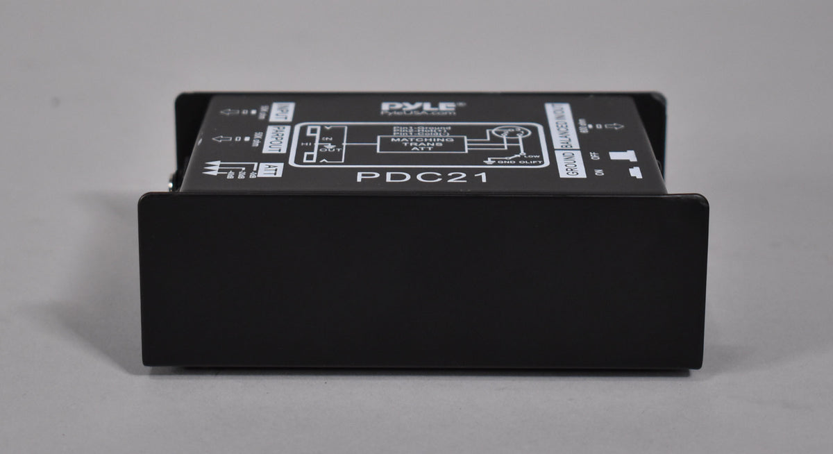 A black direct box, viewed from the front, showing the top panel with white text and diagrams, and two small toggle switches.