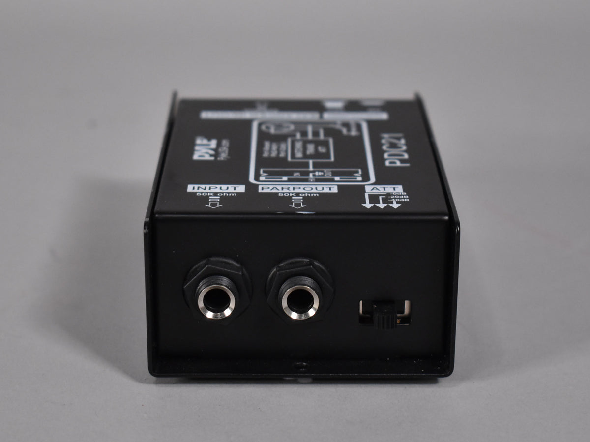 The black direct box is viewed from the front, showing two 1/4" input jacks and a small black toggle switch.