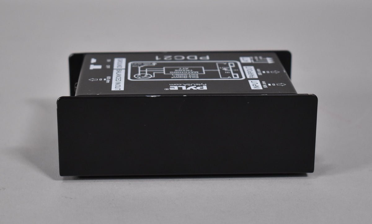 The black direct box is viewed from the front, with the top panel's white text and diagram visible at an angle.
