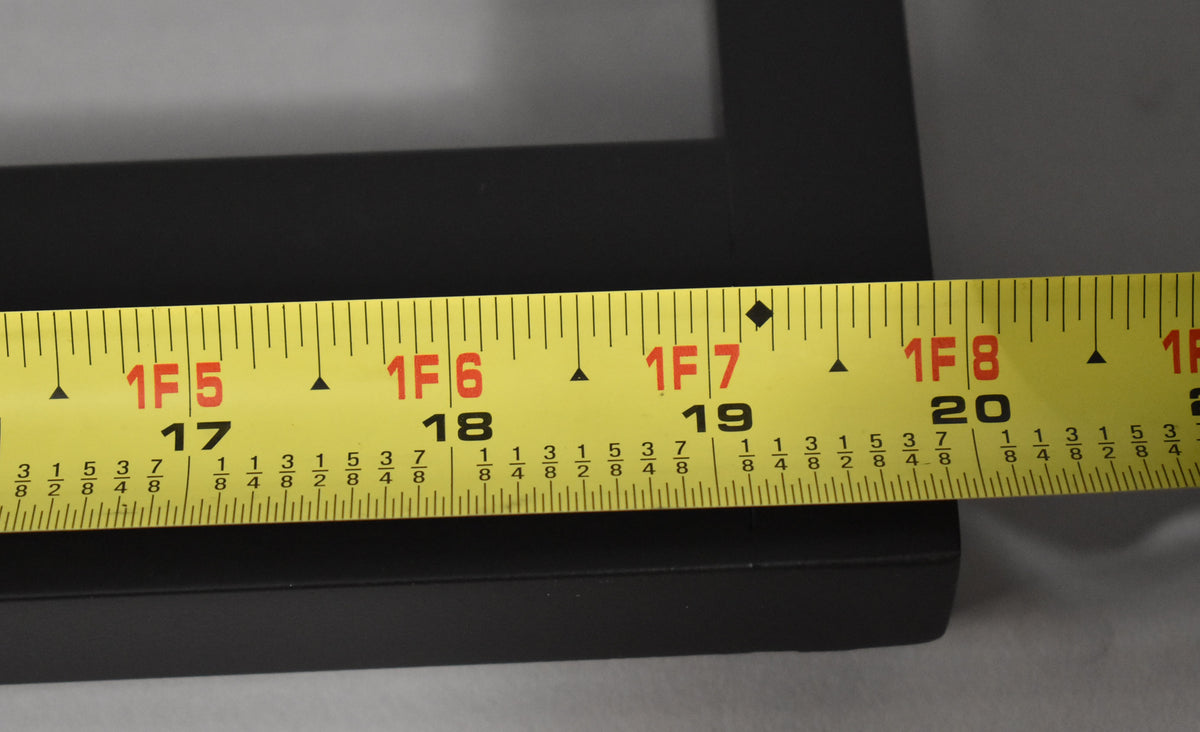 A yellow tape measure shows the black pedalboard's length from 17 to 20 inches, with a matte finish.