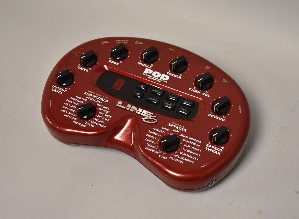 A kidney-bean-shaped, metallic red multi-effects pedal with numerous black knobs and a central black control panel with a red digital display.