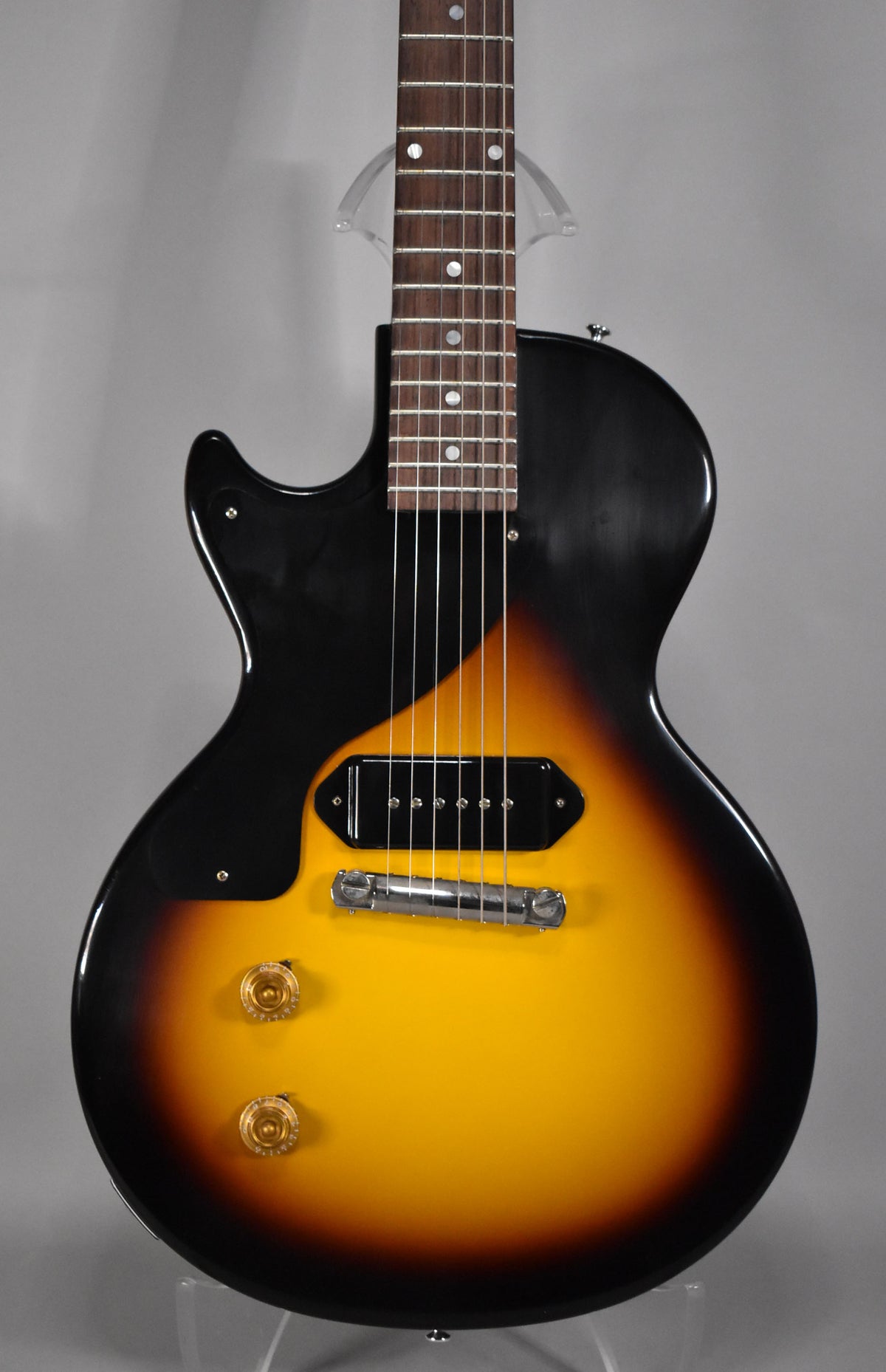 Full front view of a sunburst Les Paul Junior, showing the single black P90 pickup, chrome wraparound bridge, and gold top hat knobs.