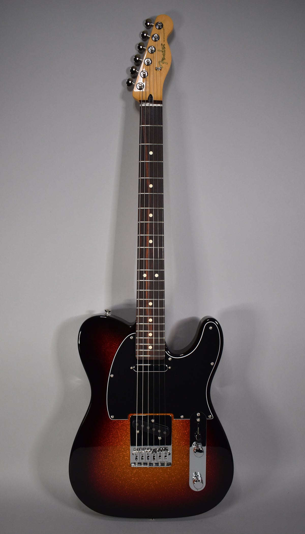 Full-length Telecaster in 3-Color Sparkle Sunburst, with a black pickguard, chrome hardware, and a rosewood fretboard.