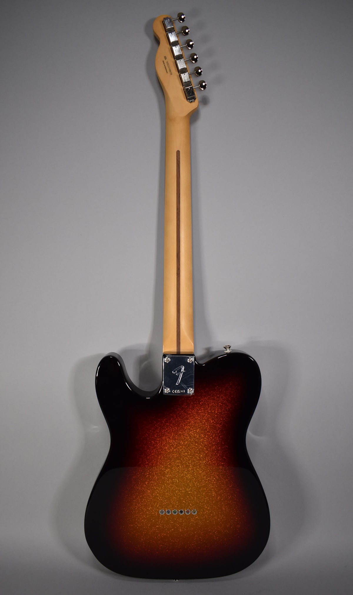 Full rear view of a Telecaster with a sparkle sunburst finish, maple neck, and chrome tuners and string-through-body ferrules.
