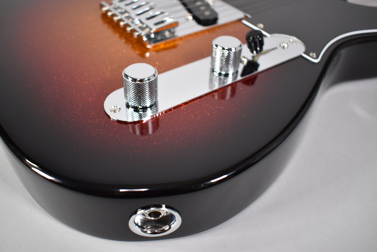 Close-up of the guitar's lower body, showing the sparkly 3-color sunburst finish, chrome control plate, knurled knobs, and output jack.