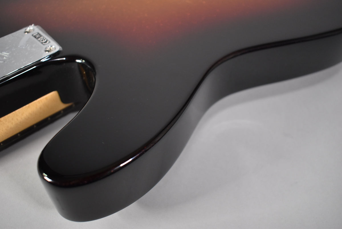 Close-up of the Telecaster's lower bout, showing the glossy 3-Color Sparkle Sunburst finish and chrome neck plate.