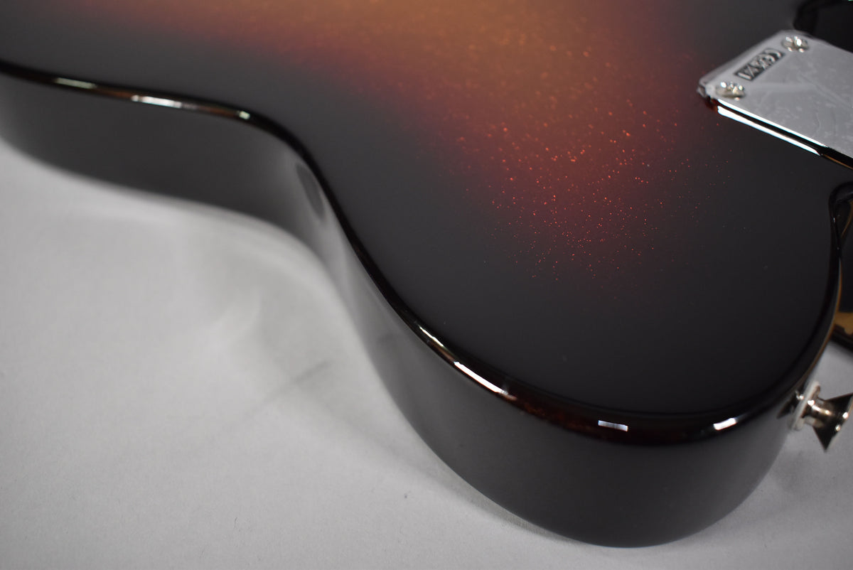 Close-up of the guitar's lower bout, showing the 3-Color Sparkle Sunburst finish with visible red glitter and a chrome bridge plate.