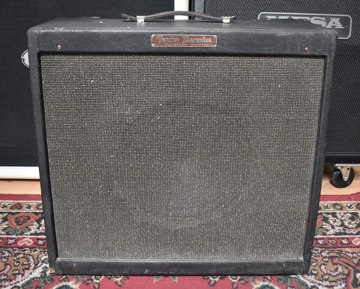 Front view of a black tweed guitar amp with a dark gray grille cloth, a leather handle, and a silver nameplate.