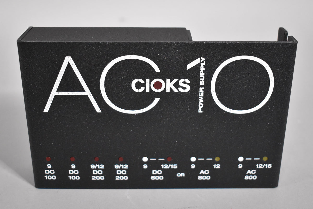 The black textured power supply is angled to show its front panel with white lettering and red indicator lights.