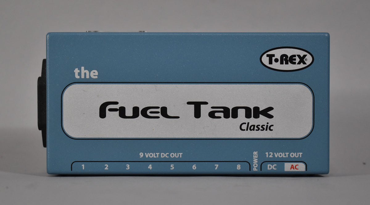 The light blue power supply is viewed from the top, showing eight 9-volt DC outputs and two 12-volt outputs (DC/AC).