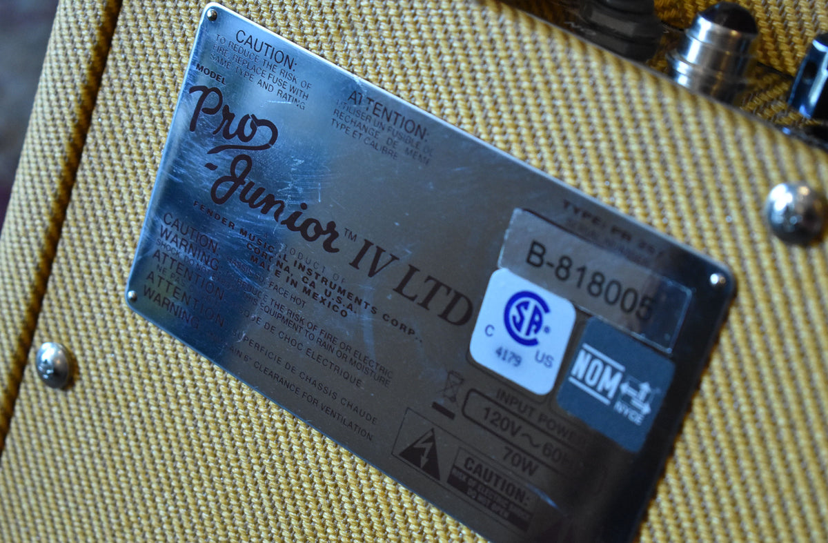 Close-up of the amplifier's rear metal plate, showing light scuffs, serial number B-818005, and power input details.