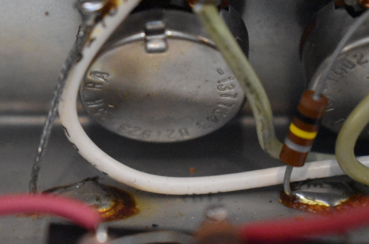 Close-up of amplifier wiring, showing a potentiometer stamped "1377343" and "B21923", with a resistor and various wires.