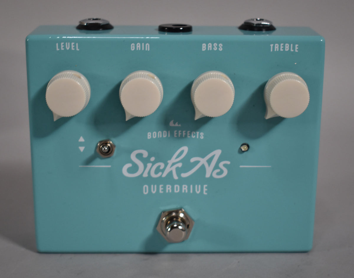 Light blue pedal with four cream knobs, a small toggle switch, and a footswitch, viewed from slightly above.