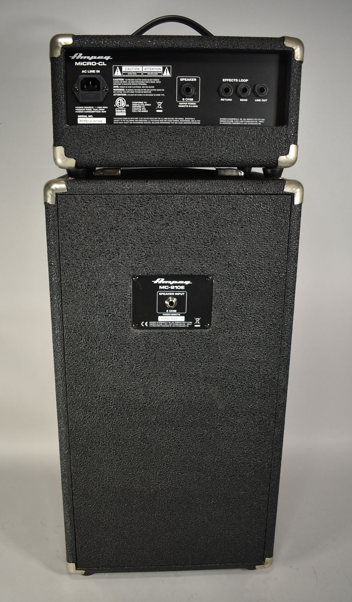 Rear view of the black textured amplifier head and speaker cabinet, showing the AC input, speaker output, and effects loop jacks.