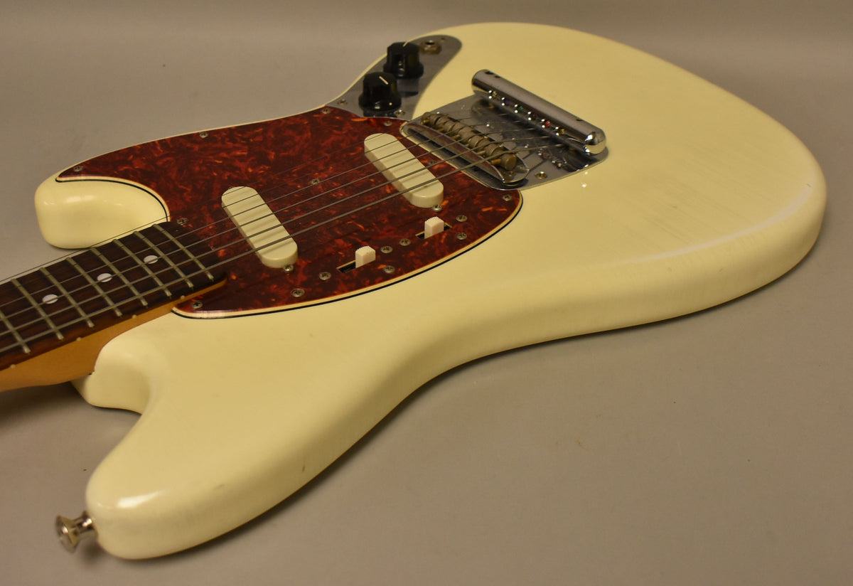 The Olympic White relic nitro finish body is shown from above, with a tortoiseshell pickguard, two single-coil pickups, and chrome hardware.