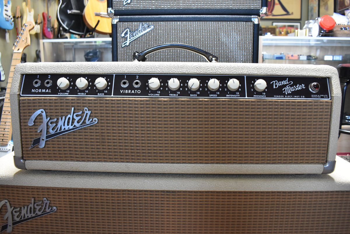 Front view of a blond amp head with a brown grille, black control panel, and white knobs, showing some wear.