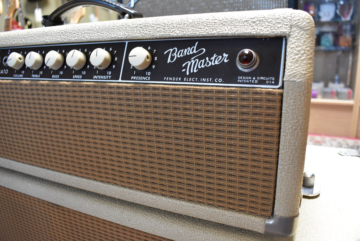 Angled close-up of the blonde amp head and top of the matching cabinet, showing the control panel with six cream knobs and a red jewel light.