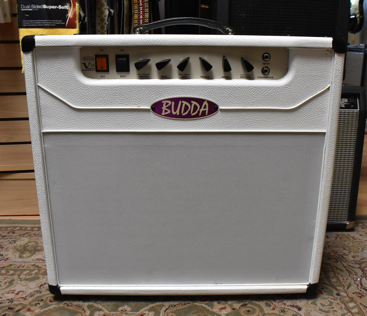 Front view of a white textured combo amp with a light grey grille, black corner protectors, and a top handle.