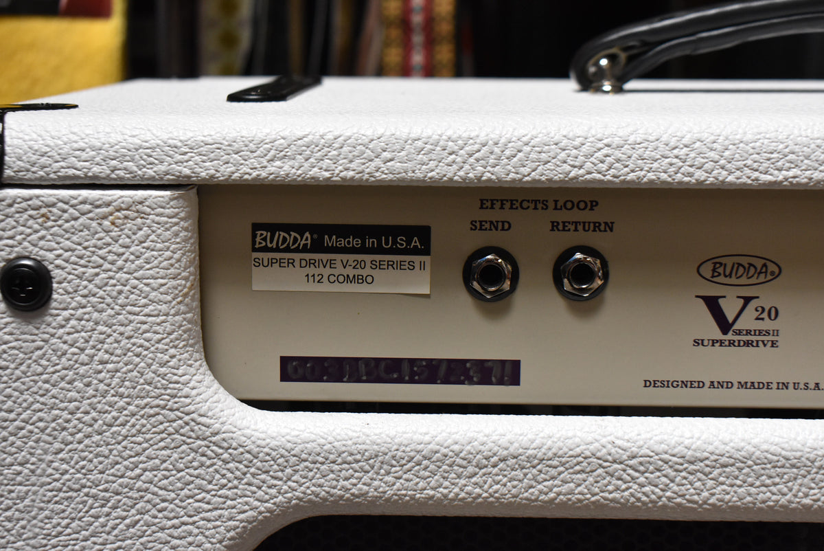 Close-up of the white textured amp's rear panel, showing the Effects Loop Send and Return jacks and a black serial number sticker.