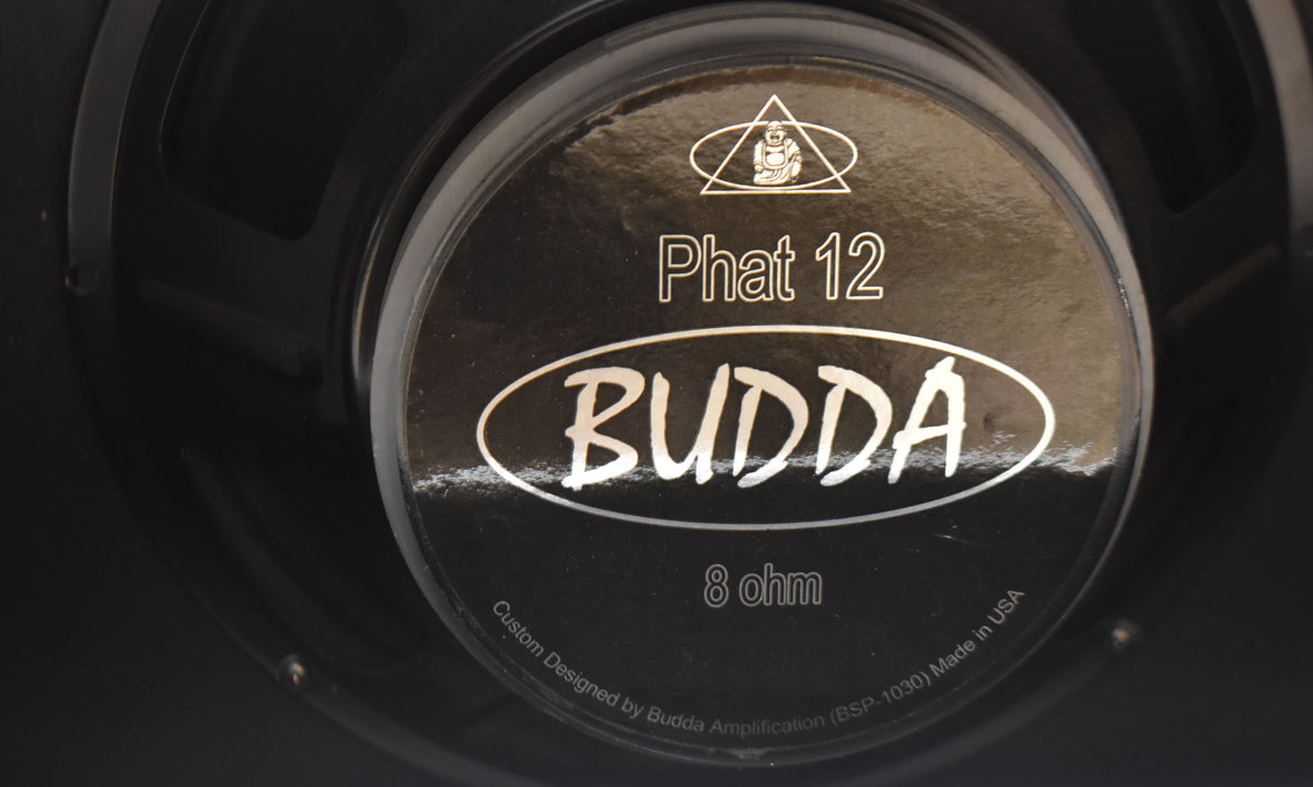 Close-up of the black speaker cone, showing the silver-on-black center cap with "Phat 12" and "8 ohm" text.