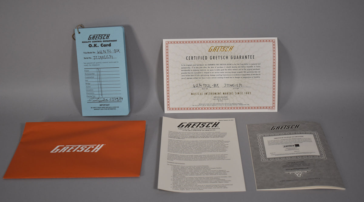 A flat lay of five Gretsch documents: a blue O.K. card, a white certified guarantee, an orange folder, and two white warranty papers.