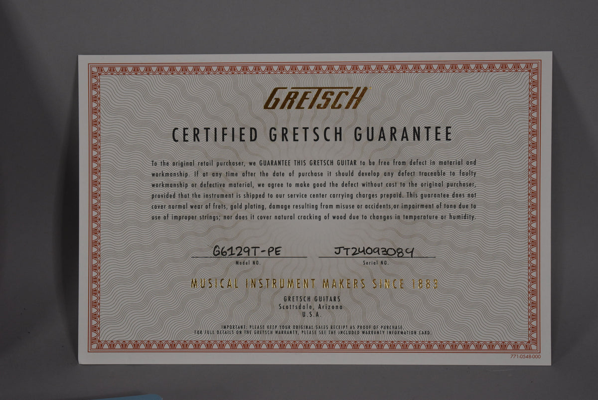 Close-up of the guitar's Gretsch Certified Guarantee card, showing model and serial numbers.