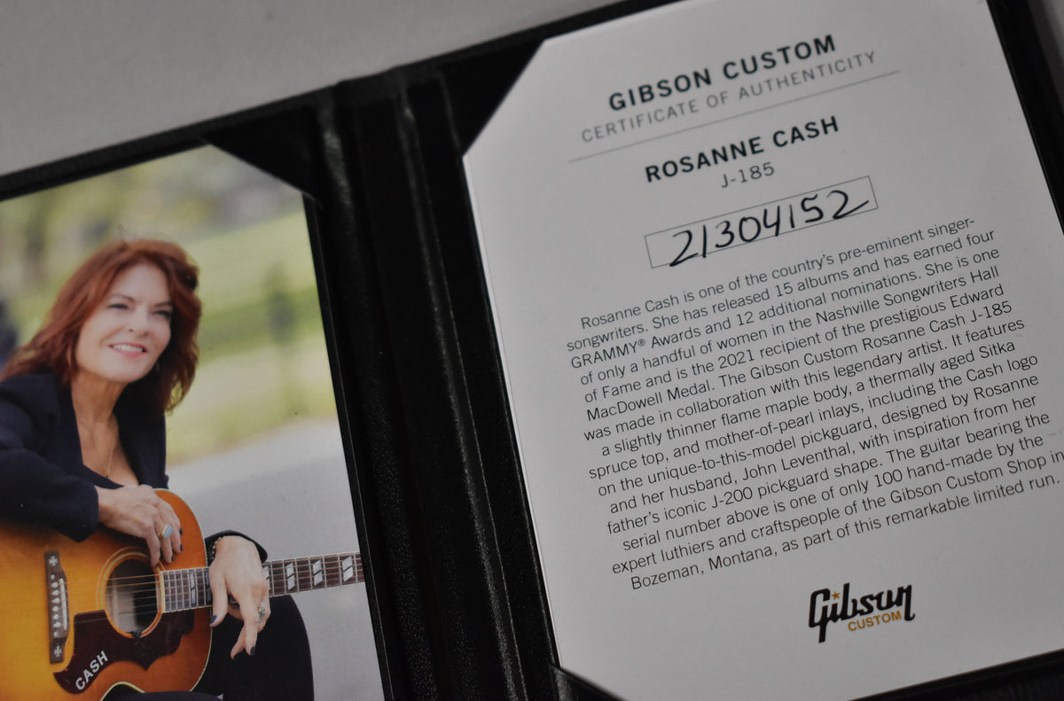A close-up of a Certificate of Authenticity for the Rosanne Cash J-185, with a photo of Rosanne Cash holding the guitar.
