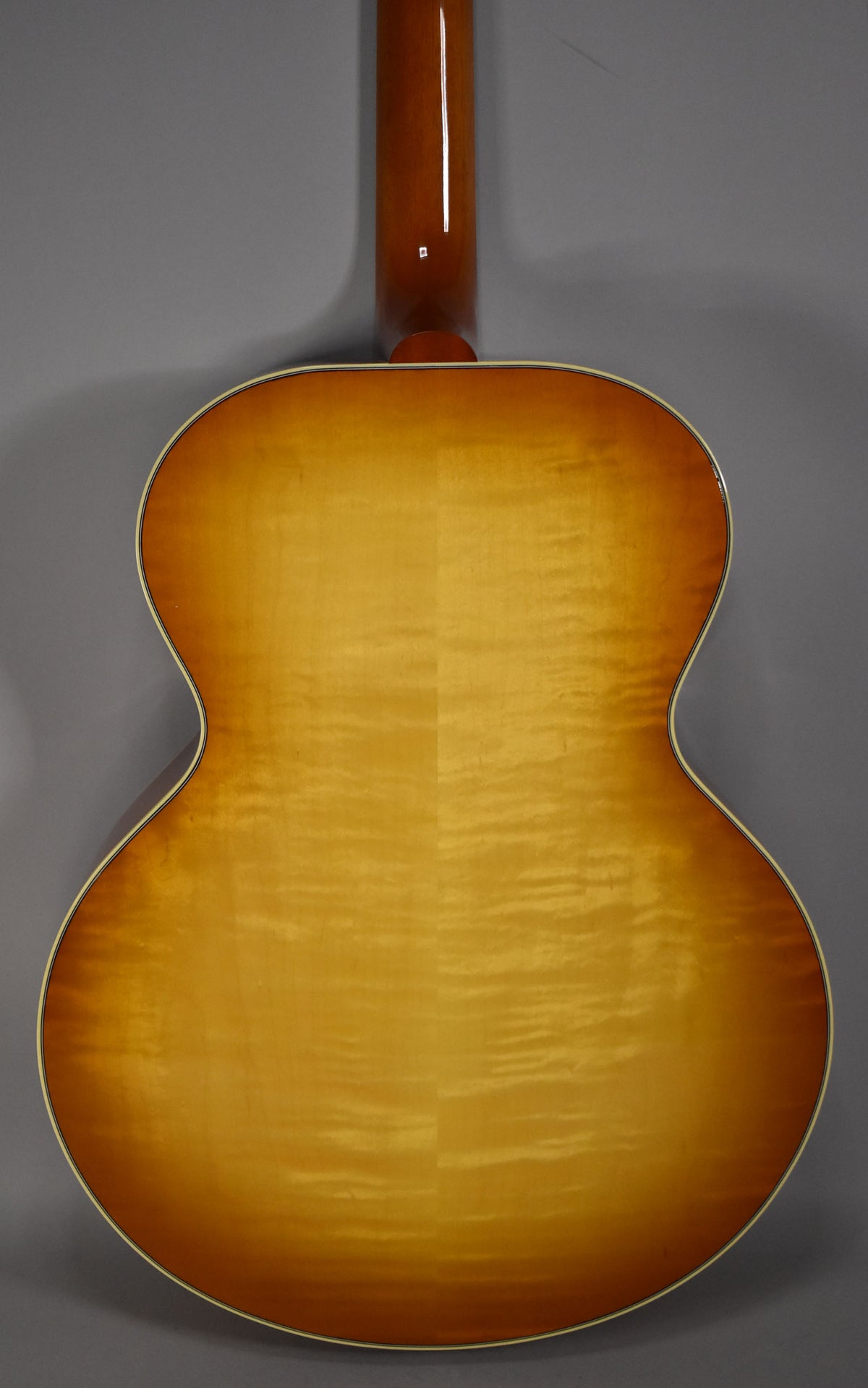 The guitar's back and neck are shown, revealing a cherry sunburst finish with prominent flame maple wood grain and cream binding.