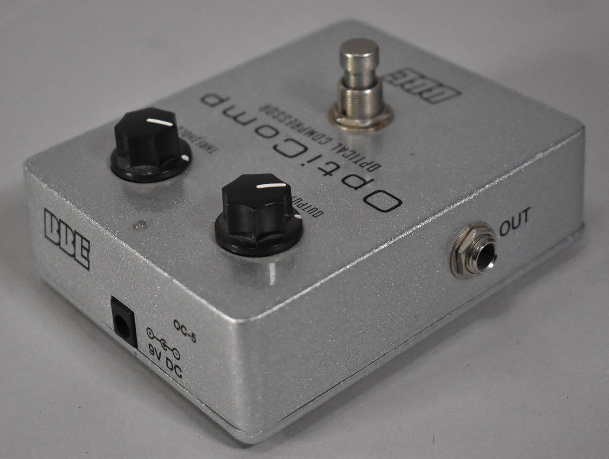 Silver-sparkle pedal, viewed from the front-right, with two black control knobs, a footswitch, and an output jack.
