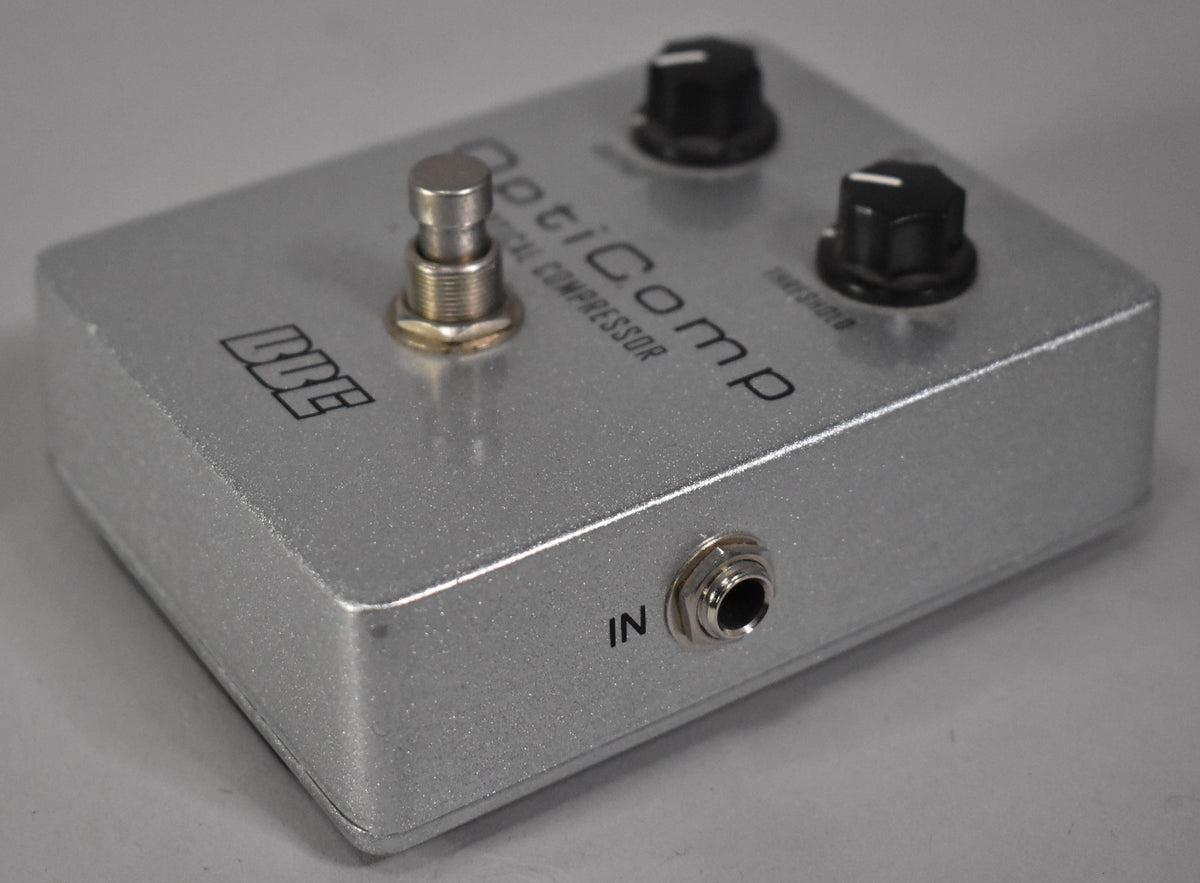 A silver guitar pedal with a footswitch, two black control knobs, and an "IN" jack, viewed from the front-right.